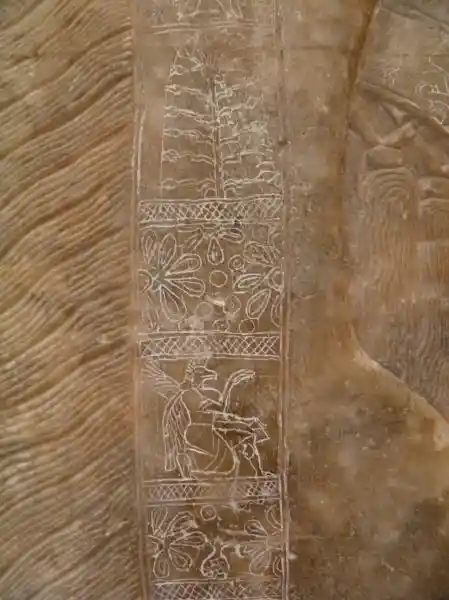 Tree of life, flowers, nisroch and other symbols engraved on marble in the palace of king Assurnasirhpal II